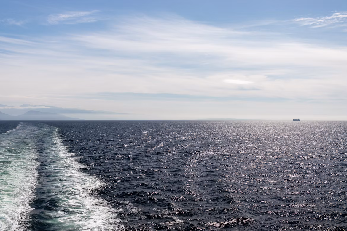 The rippling water trail of a ferry at sea